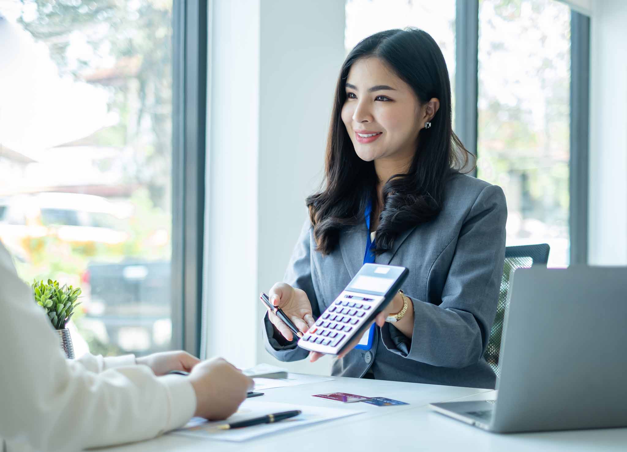 Asian business customer service representatives work and smile s